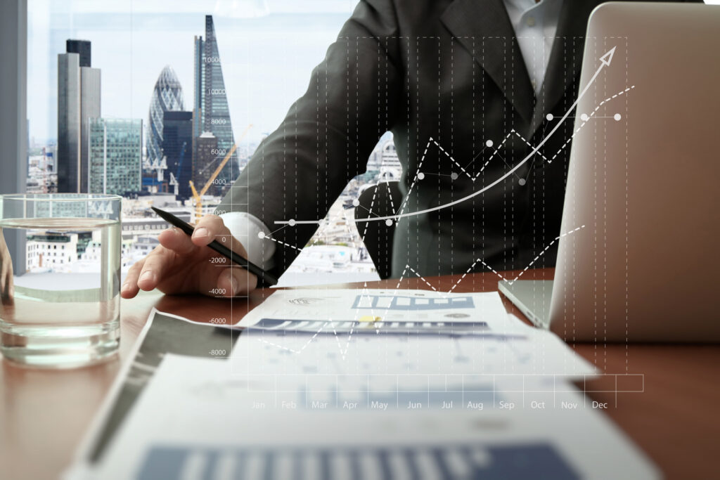 Über uns 3 business documents on office table with smart phone and digital